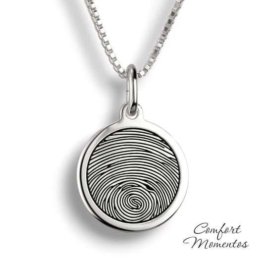 Silver round necklace with a black fingerprint engraved