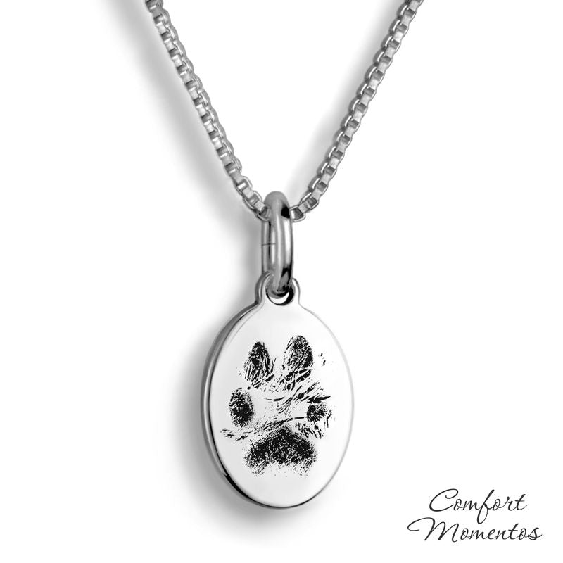 Small silver oval necklace with black pawprint engraving