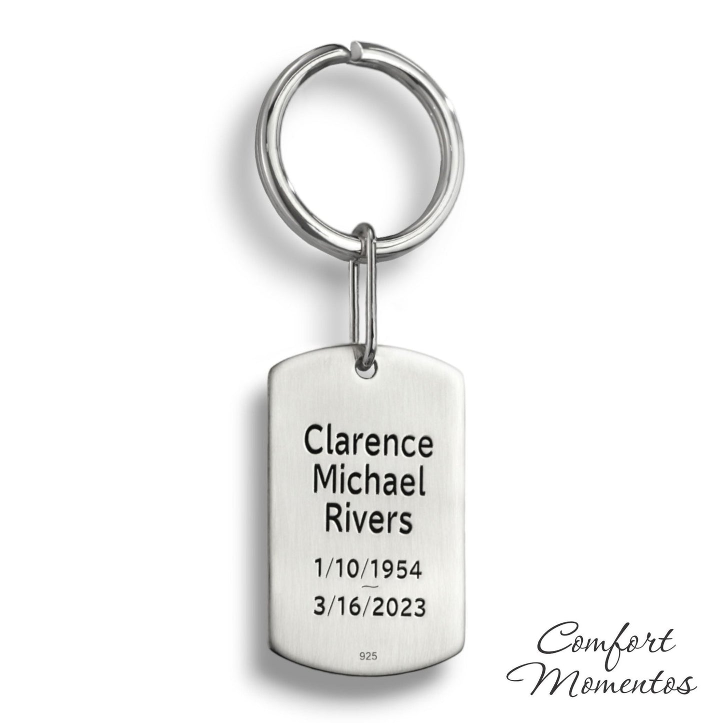 Back of silver dog tag keychain with engraved black example text, on a round split key ring