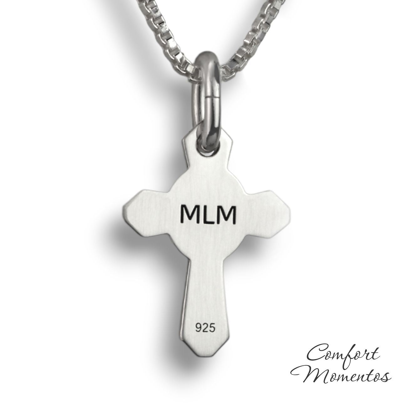Back of small silver cross necklace with MLM engraved in black letters