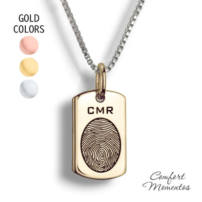 Small gold dog tag necklace with a black fingerprint engraved