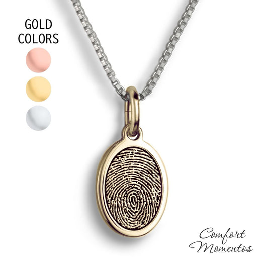 Small gold oval necklace with a black fingerprint engraved
