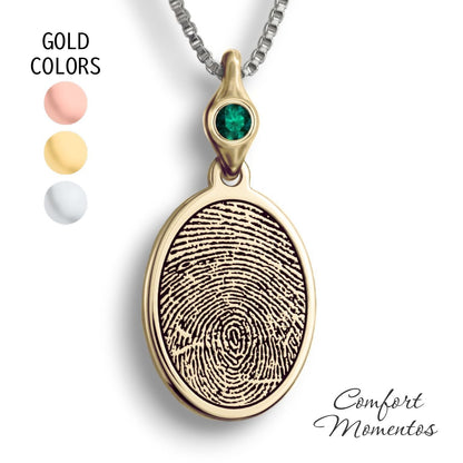 Gold oval necklace with a black fingerprint engraved, with a gemstone urn
