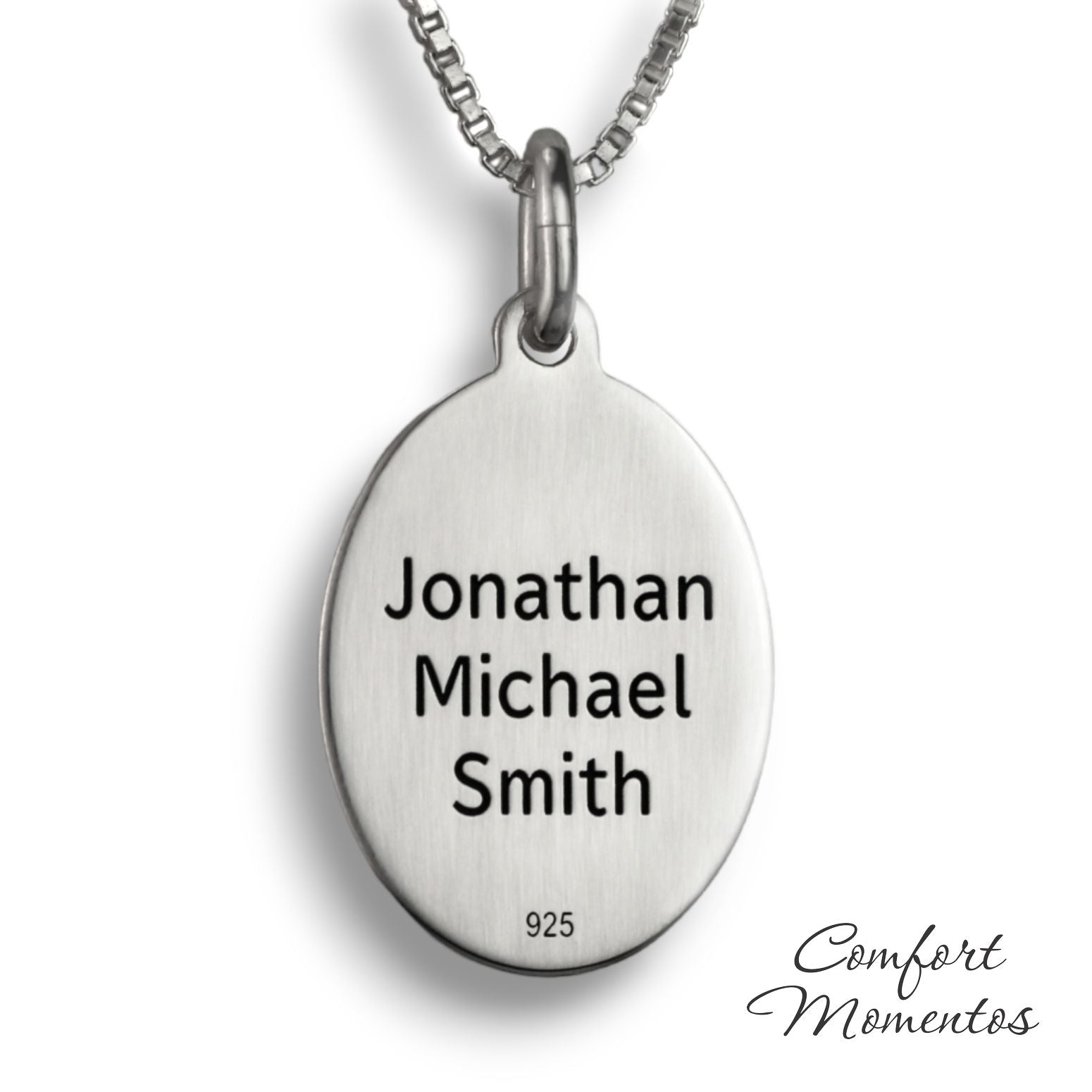 Back of silver oval necklace, with black example text engraved
