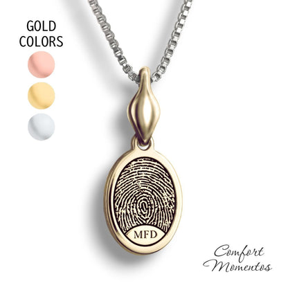 Small gold oval necklace with a black fingerprint and initials engraved, with a plain urn