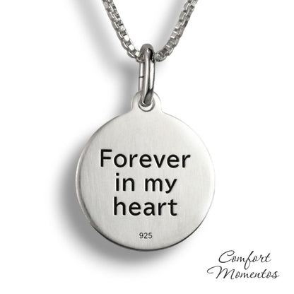 Back of silver round necklace, with black example text engraved