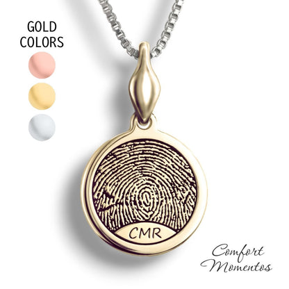 Gold round necklace with a black fingerprint and initials engraved, with a plain urn