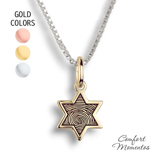 Small gold star necklace with a black fingerprint engraved