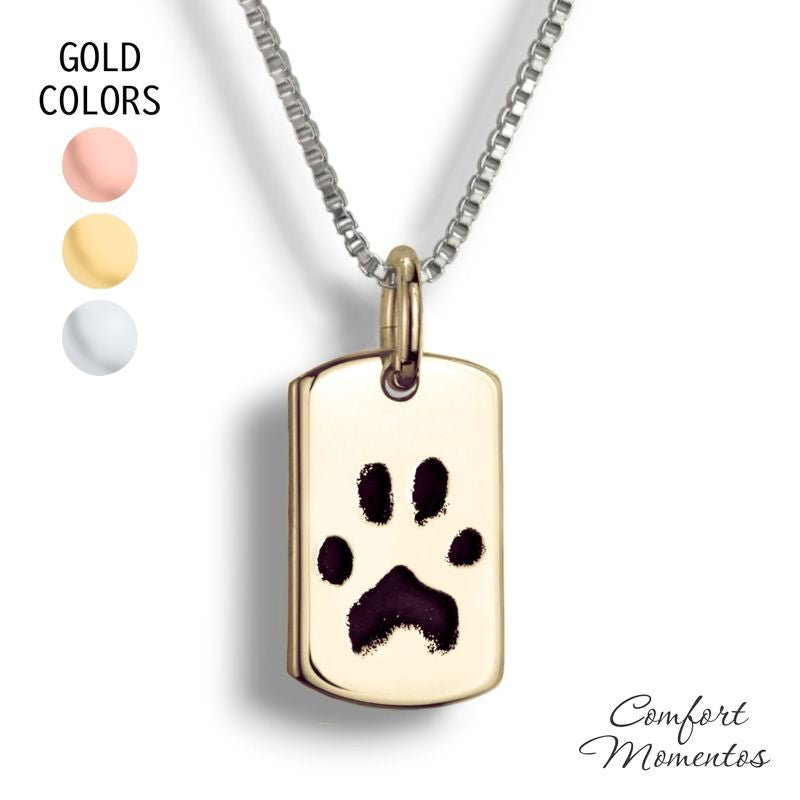 Small gold dog tag necklace with black pawprint engraving