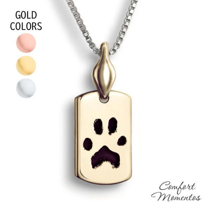 Small gold dog tag necklace with black pawprint engraving, with a plain urn