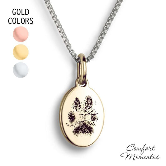 Small gold oval necklace with black pawprint engraving