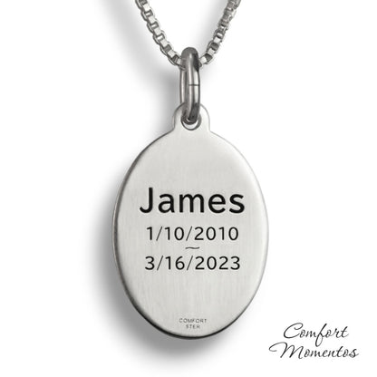 Back of silver oval necklace, with black example text engraved