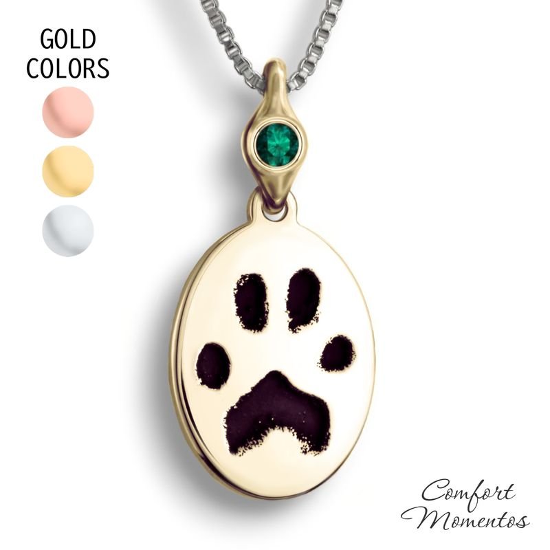 Gold oval necklace with black pawprint engraving, with a gemstone urn