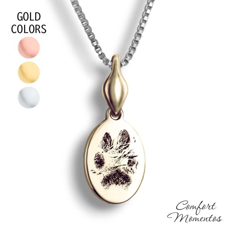 Small gold oval necklace with black pawprint engraving, with a plain urn