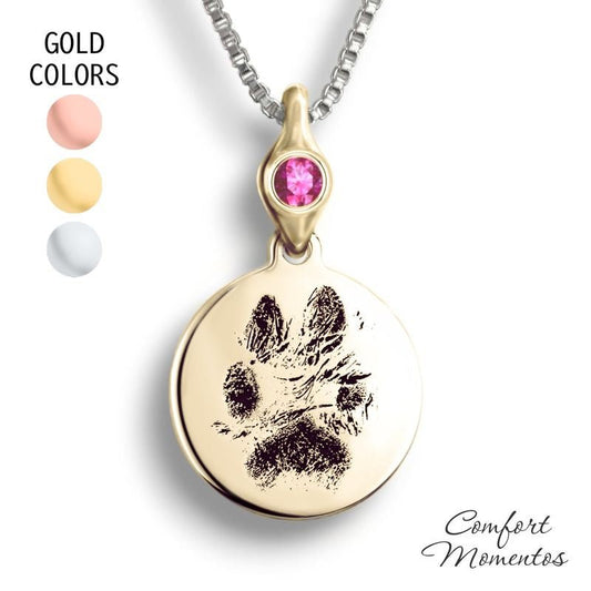 Gold round necklace with black pawprint engraving, with a gemstone urn