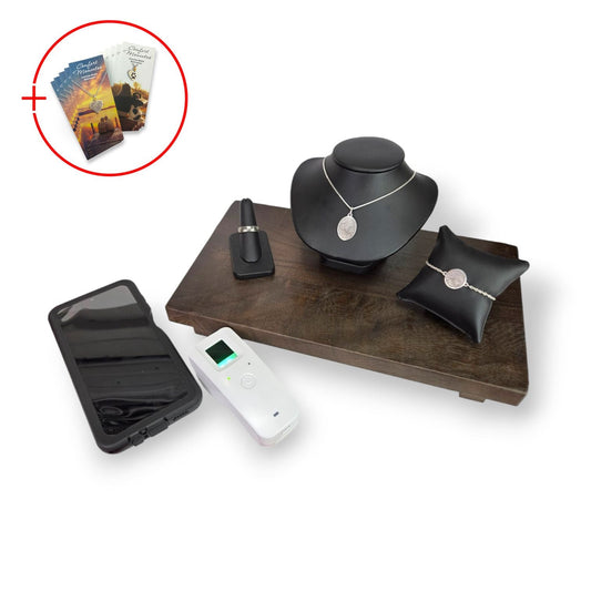Fingerprint jewelry displayed on black leather with a wooden base next to a fingerprint scanner and phone