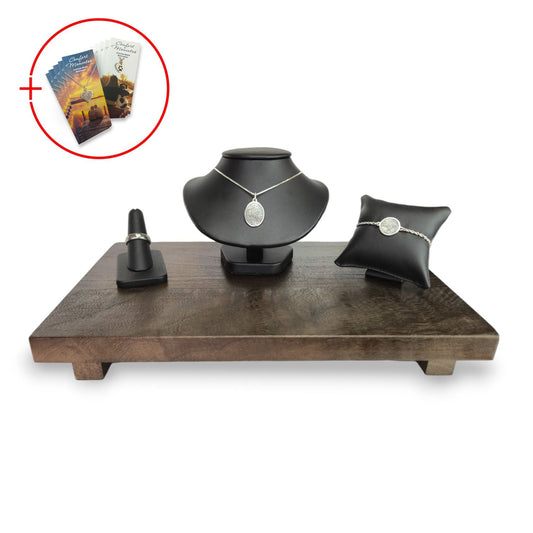 Fingerprint jewelry displayed on black leather, with a wooden base