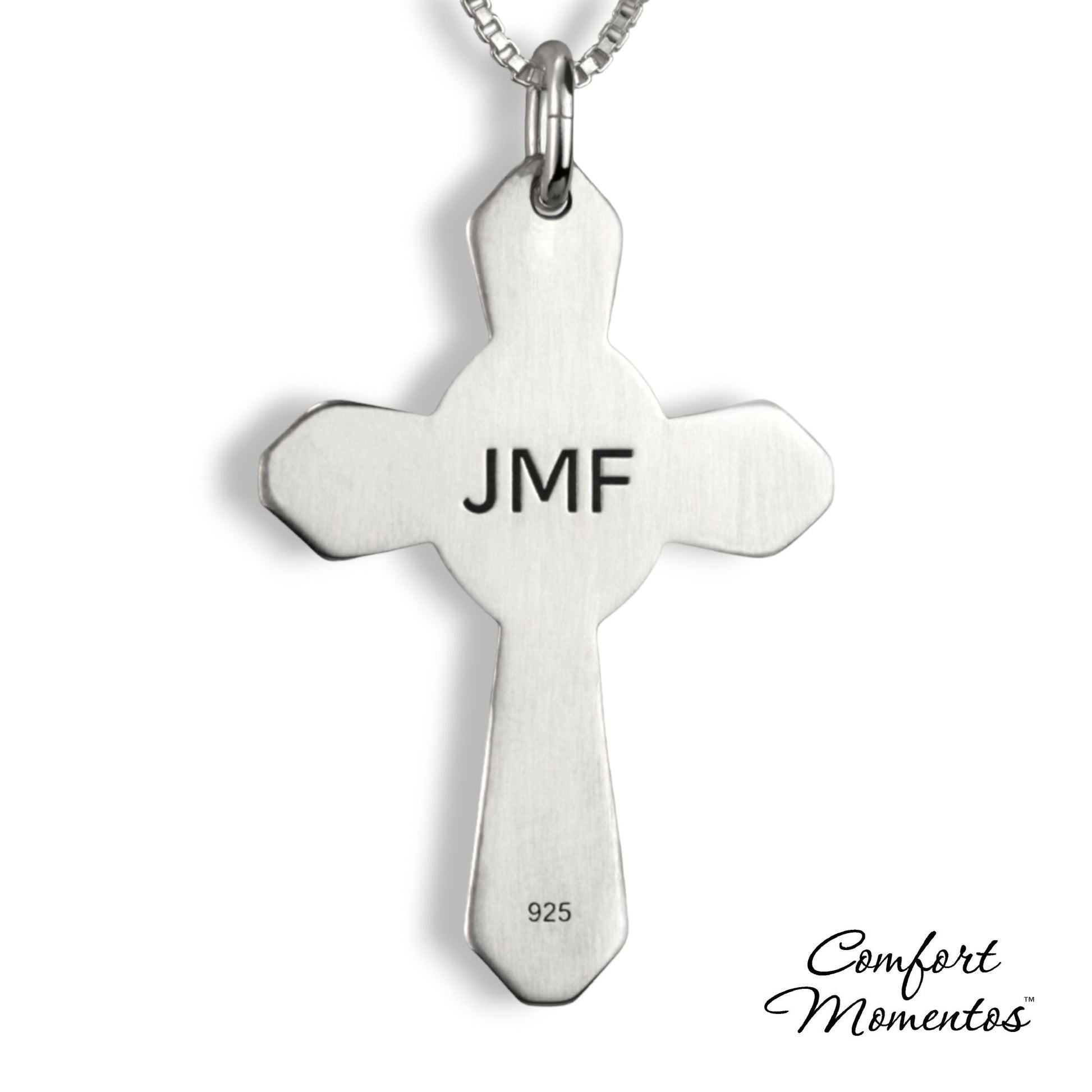 Back of silver cross necklace with JMF engraved in black letters