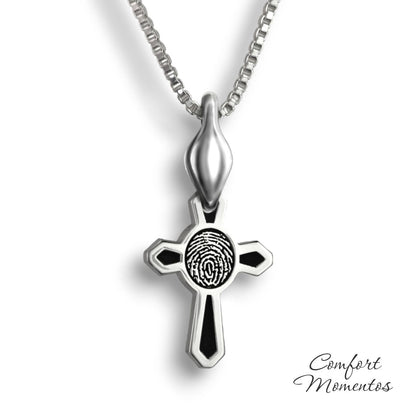 Small silver cross necklace with black fingerprint and recessed black areas, with a plain urn