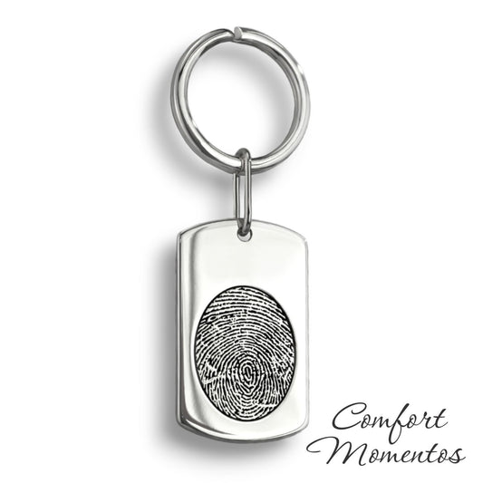 Silver dog tag keychain with a black fingerprint engraved, on a round split key ring