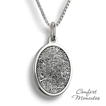 Silver oval necklace with a black fingerprint engraved
