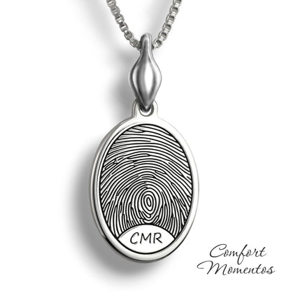 Silver oval necklace with a black fingerprint and initials engraved, with a plain urn