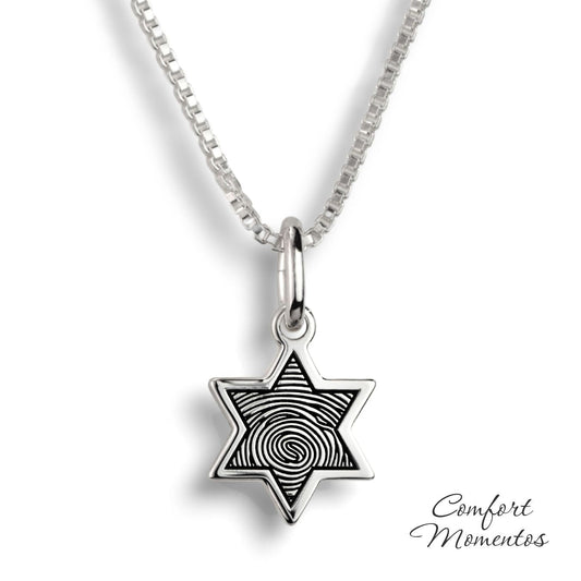 Small silver star necklace with a black fingerprint engraved
