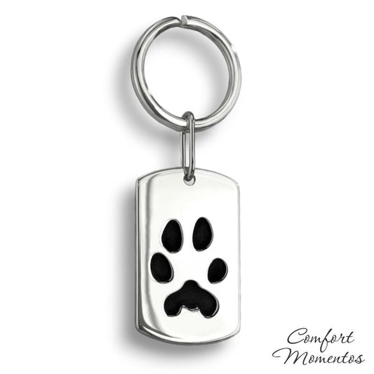 Silver dog tag keychain with black pawprint engraving, on a round split key ring