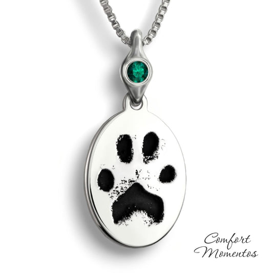 Silver oval necklace with black pawprint engraving, with a gemstone urn